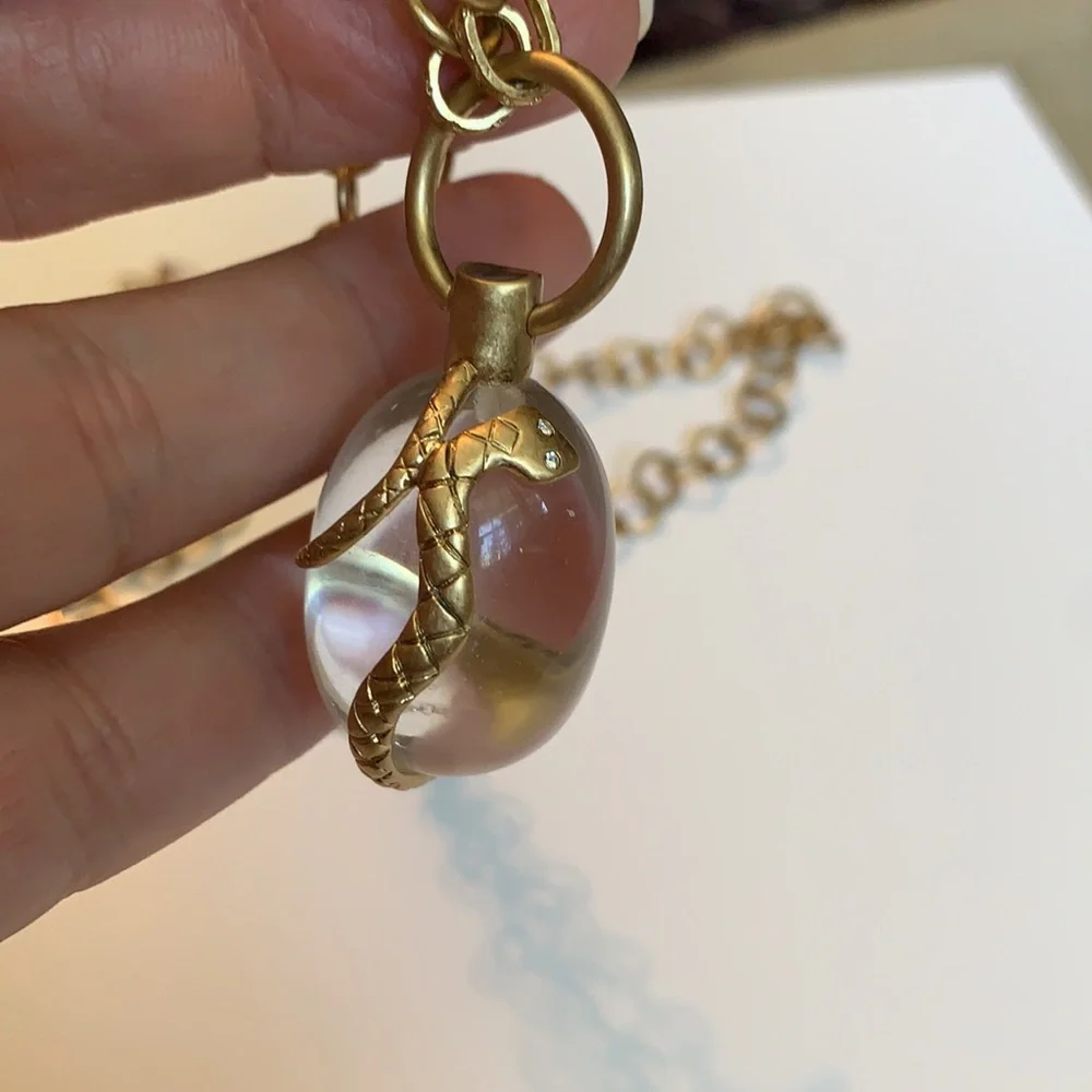 Vintage golden Snake wrapped around an elongated oval crystal